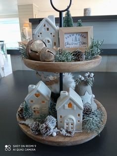 three tiered tray with small houses and decorations on it's sides for display