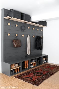 an image of a room with shoes and bags on the wall, next to a rug