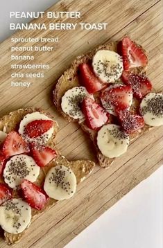 two pieces of toast with strawberries and bananas on top, sitting on a cutting board