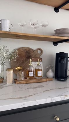 a kitchen counter topped with lots of bottles and glasses