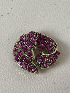 Elevate your accessory game with this stunning Vintage Pink Rhinestone Brooch. ' This elegant piece features a dazzling arrangement of pink rhinestones, capturing light beautifully and adding a touch of glamour to any outfit. Perfect for pinning on jackets, blouses, or scarves, it also serves as a decorative accent for your favorite pieces.  This brooch, with its vintage charm, was originally owned by my grandmother and remains in excellent condition with no visible signs of wear or damage (she' Pink Brooch Pins For Party, Pink Party Brooch Pins, Pink Brooch Pin For Formal Occasions, Pink Rhinestone Brooches For Formal Occasions, Pink Rhinestone Brooches For Gifts, Pink Rhinestone Brooches As Gift, Formal Pink Brooch Pin, Pink Rhinestone Party Brooch, Pink Rhinestone Party Brooches