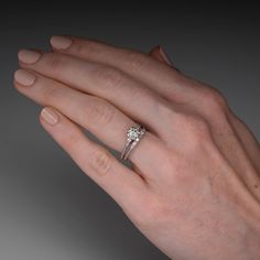 a woman's hand with a diamond ring on it