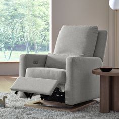 a recliner chair sitting on top of a white rug