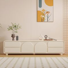 a living room scene with focus on the sideboard and vases in the foreground