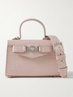 Versace's mini bag is adorned with the house's signature 'Medusa' logo, which the founder plucked from the ancient ruins of Italy's Reggio di Calabria. Made from croc-effect leather, it has a detachable shoulder strap and compact silhouette sized to fit your keys, cards and a favorite lipstick. Versace Bag, Versace Pink, Lavender Bags, Versace Bags, Luxury Purses, Ancient Ruins, Cute Bags, Designer Bags, Bag Straps