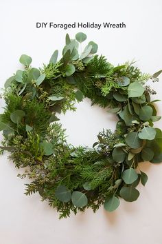 a wreath made out of green leaves and greenery on a white background with the words diy foraged holiday wreath