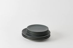 five black plates stacked on top of each other