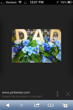 an iphone photo with the word dad on it and blue flowers in front of it