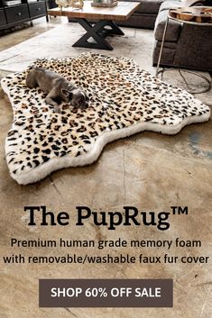 a dog laying on top of a leopard print rug