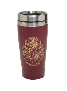 the hogwarts crest is engraved on this red stainless steel tumbler cup with gold trim