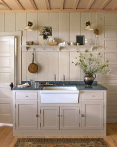 a kitchen with white cabinets and blue counter tops