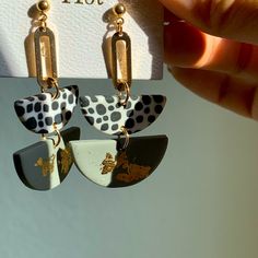 a pair of earrings is being held up