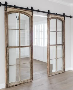 an open window with sliding glass doors on the inside and outside, in front of a white wall