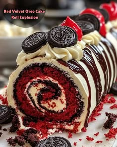 red velvet oreo cake roll explosion with oreos and cream frosting on top