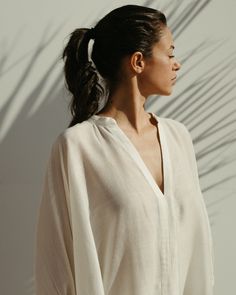 Gaia linen kaftan dress in jasmine white - Soukra Elegant White V-neck Kaftan, Spring Linen V-neck Kaftan, Chic White Flowy Kaftan, White Relaxed Fit Maxi Dress For Loungewear, White V-neck Maxi Dress For Loungewear, Elegant Relaxed Fit Dress For Loungewear, Elegant Beach Tunic For Spring, Daywear Relaxed Fit Tunic With Split Neck, Chic White Maxi Dress For Loungewear