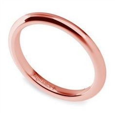 a rose gold wedding ring on a white background