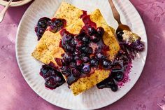 a white plate topped with blueberries and cheese