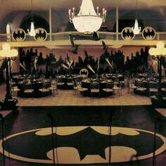 an image of a bat themed party setting with tables and chandeliers on the ceiling