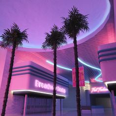 two palm trees in front of a building with neon lights on the outside and inside