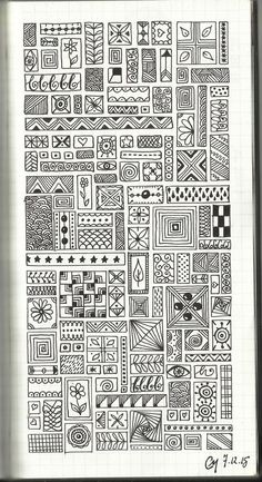 a notebook with an intricate pattern on the cover and some lines drawn in black ink