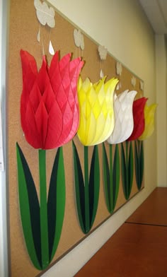 some paper flowers are hanging on the wall