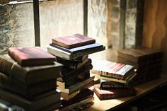 a stack of books sitting on top of a wooden table