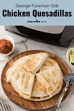 chicken quesadillas on a wooden plate next to a toaster and bowl of salsa