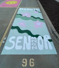 a painted sign on the side of a road that says seniors and 39 below it