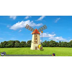 a large windmill sitting on top of a lush green field next to a blue sky