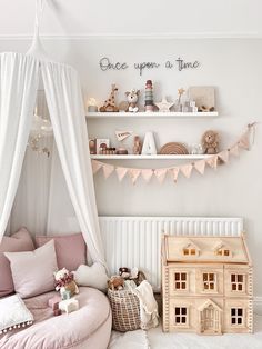 a room with pink furniture and white curtains on the windowsill is decorated in pastel tones