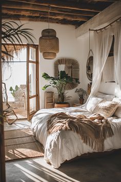 a bed with white sheets and pillows in a bedroom next to a window, potted plant and wicker baskets