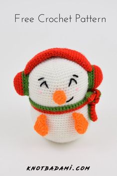 a crocheted penguin with a red hat and scarf