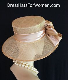 Ladies Metallic Gold And Champagne Beige  Wide Brim Sinamay Straw Designer Fashion Church Wedding Hat. The Bow Can Be Worn Toward The Front Of The Face Or Toward The Back Of The Head. This Dress Hat Is Suited For Weddings, Formals, Bridal, Mother Of The Bride, The Kentucky Derby, The Melbourne Cup, The Royal Ascot,  And Horse Races.

Measurements: Crown Measures 22.5".  This lovely headpiece is suited for Spring, Summer or Early Fall.

All Sales Are Final. Fitted Cream Straw Hat With Curved Brim, Beige Boater Hat For Wedding, Cream Top Hat With Short Brim And Fitted Design, Cream Fitted Mini Hat With Wide Brim, Cream Fitted Wide Brim Mini Hat, Fitted Sinamay Brimmed Top Hat, Adjustable Brimmed Straw Hat For Wedding, Fitted Wide Brim Sinamay Top Hat, Cream Straw Hat For Spring Wedding