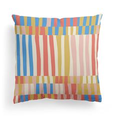 an orange, yellow and blue striped pillow on a white background with vertical stripes in different colors