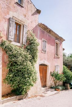 an image of a house with vines growing on the outside and in front of it