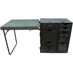 an old metal desk with drawers on it