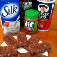 chocolate bars, milk, yogurt and other ingredients on a white plate sitting on a wooden table