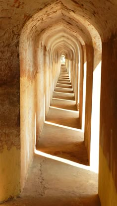 the tunnel is lined with concrete and has light coming in from one end that leads to another