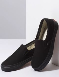 Vans Classic Slip-On shoes. The Canvas Classic Slip-on has a low profile, slip-on canvas upper with elastic side accents, Vans flag label and Vans original Waffle Outsole. Imported. Black Closed Toe Slip-ons With Rubber Sole, Black Closed Toe Casual Slip-ons, Black Slip-ons With Rubber Sole And Flat Heel, Casual Black Slip-ons With Flat Heel, Black Closed Toe Slip-ons With Cushioned Footbed, Black Low-top Slip-ons With Rubber Sole, Black Synthetic Slip-ons, Black Slip-ons With Cushioned Footbed And Flat Heel, Black Slip-ons For Streetwear