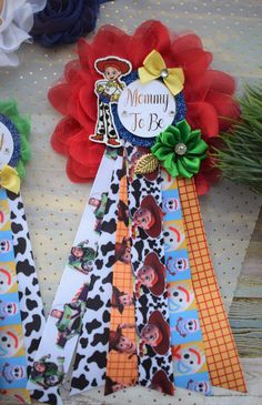 two ribbons that have been placed next to each other on a table with flowers and decorations