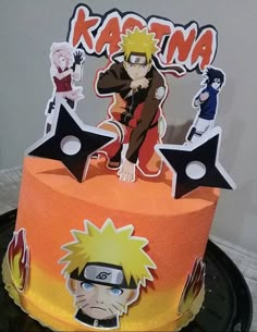 a birthday cake decorated with the characters of naruto and sashika on top