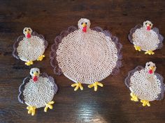 six crocheted turkey coasters on a wooden table