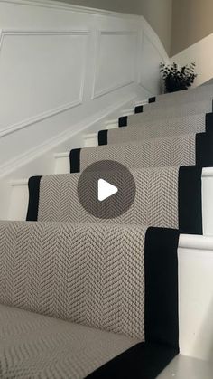 the stairs are lined with black and white carpet