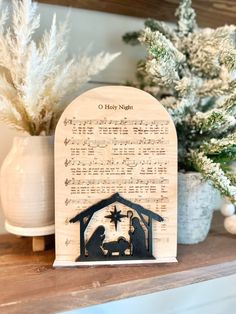 a nativity scene is displayed on a mantel