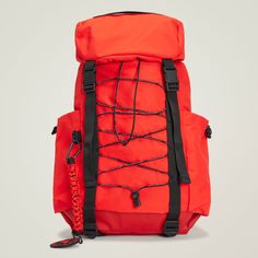 an orange backpack with black straps on it