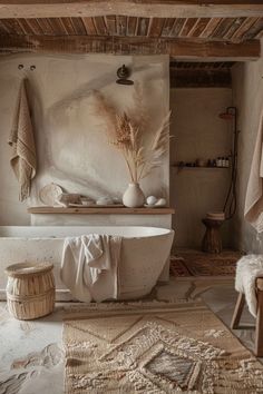 a rustic bathroom with an old bathtub and rugs