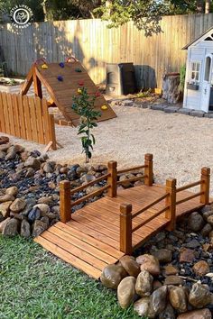 there is a small wooden bridge in the yard