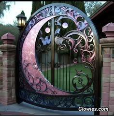 a pink and blue gate that has a crescent design on the top with flowers in it