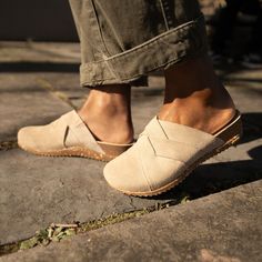 With soft, interwoven suede uppers and a cork-based sole, Daniella is sure to be your go-to mule. Suede Slip-on Sandals With Woven Sole, Suede Mules With Leather Sole And Flat Heel, Suede Mules With Cork-bed Midsoles, Slip-on Suede Mules With Cork-bed Midsoles, Casual Suede Mules With Cork-bed Midsoles, Casual Leather Mules With Textured Footbed, Beige Suede Closed Toe Clogs, Beige Suede Casual Clogs, Casual Beige Suede Clogs