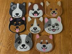 six dog patches with different designs on them sitting on a wooden floor next to a pair of scissors